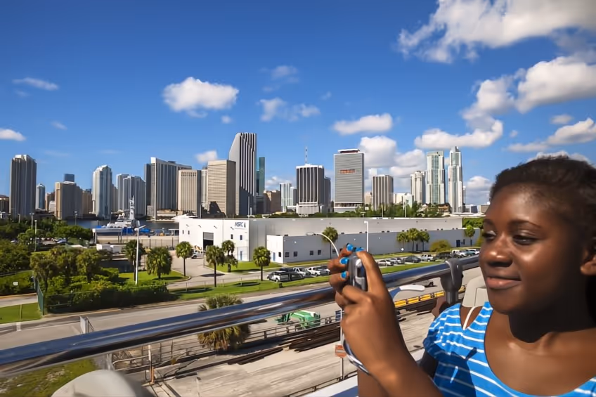 Smiling young lady taking pictures of the scenery on top of the bus