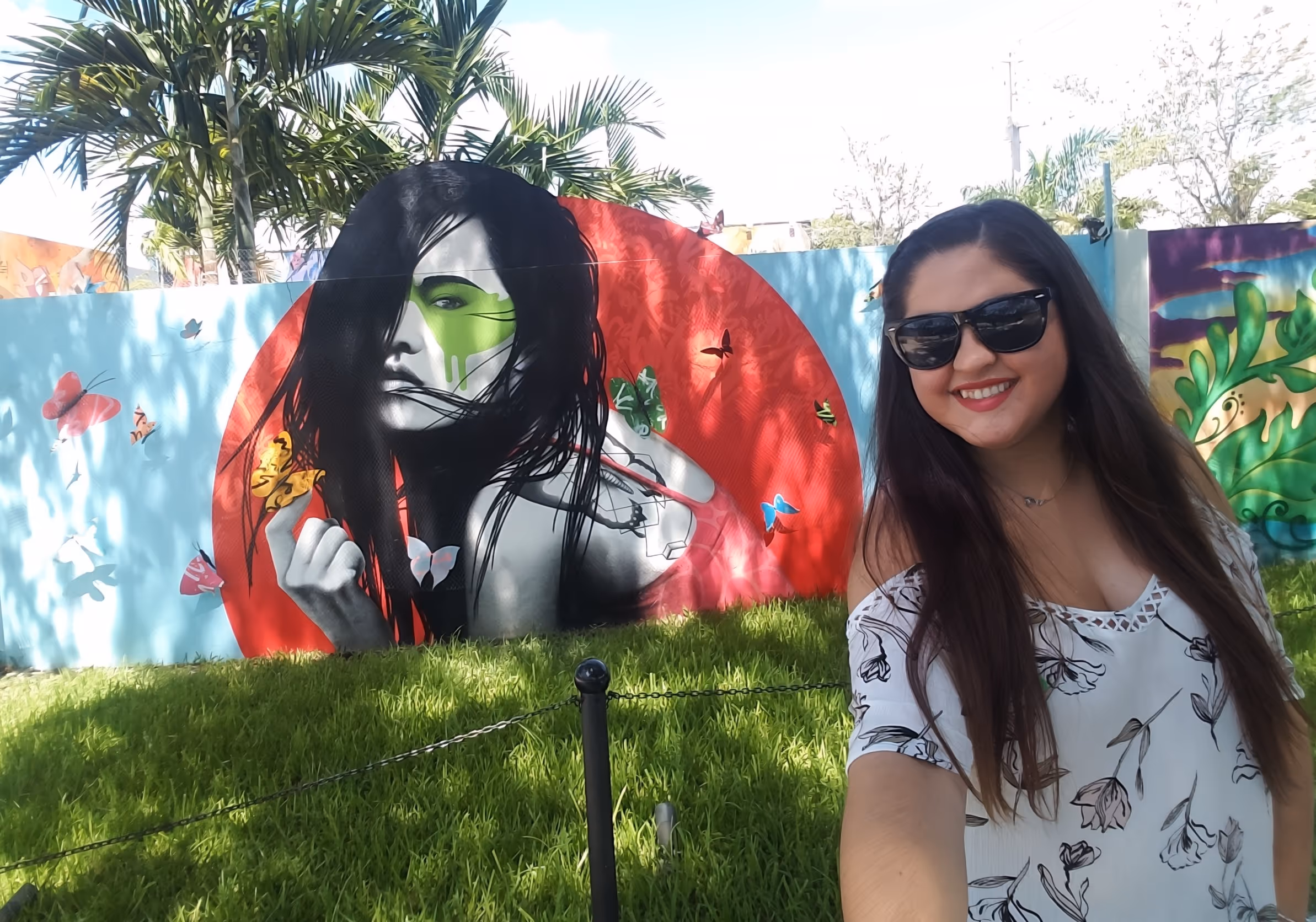 Young lady taking a selfie in front of a mural in Wynwood