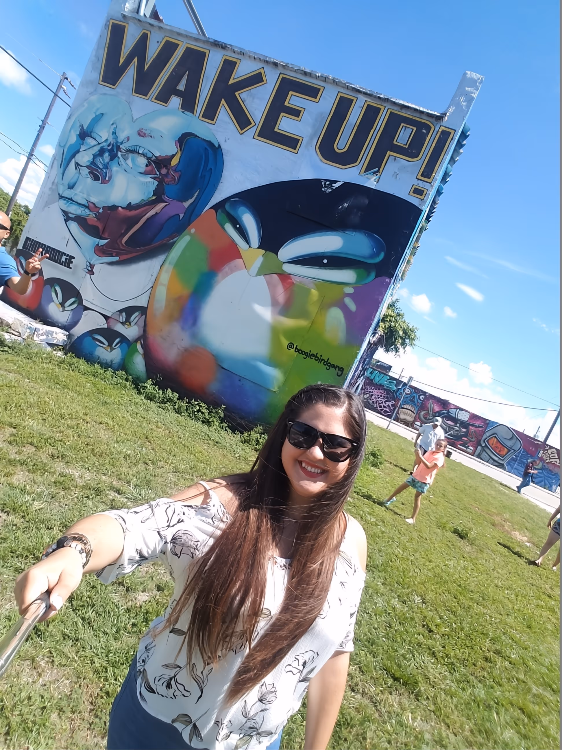 Young lady talking a selfie near the Wake Up mural in Wynwood