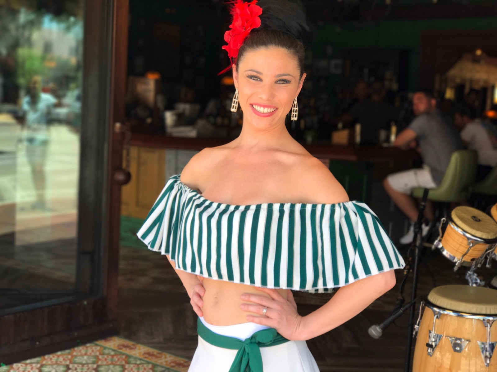 Beautiful flamenco dancer dressed in a Cuban-themed costume performing in Little Havana