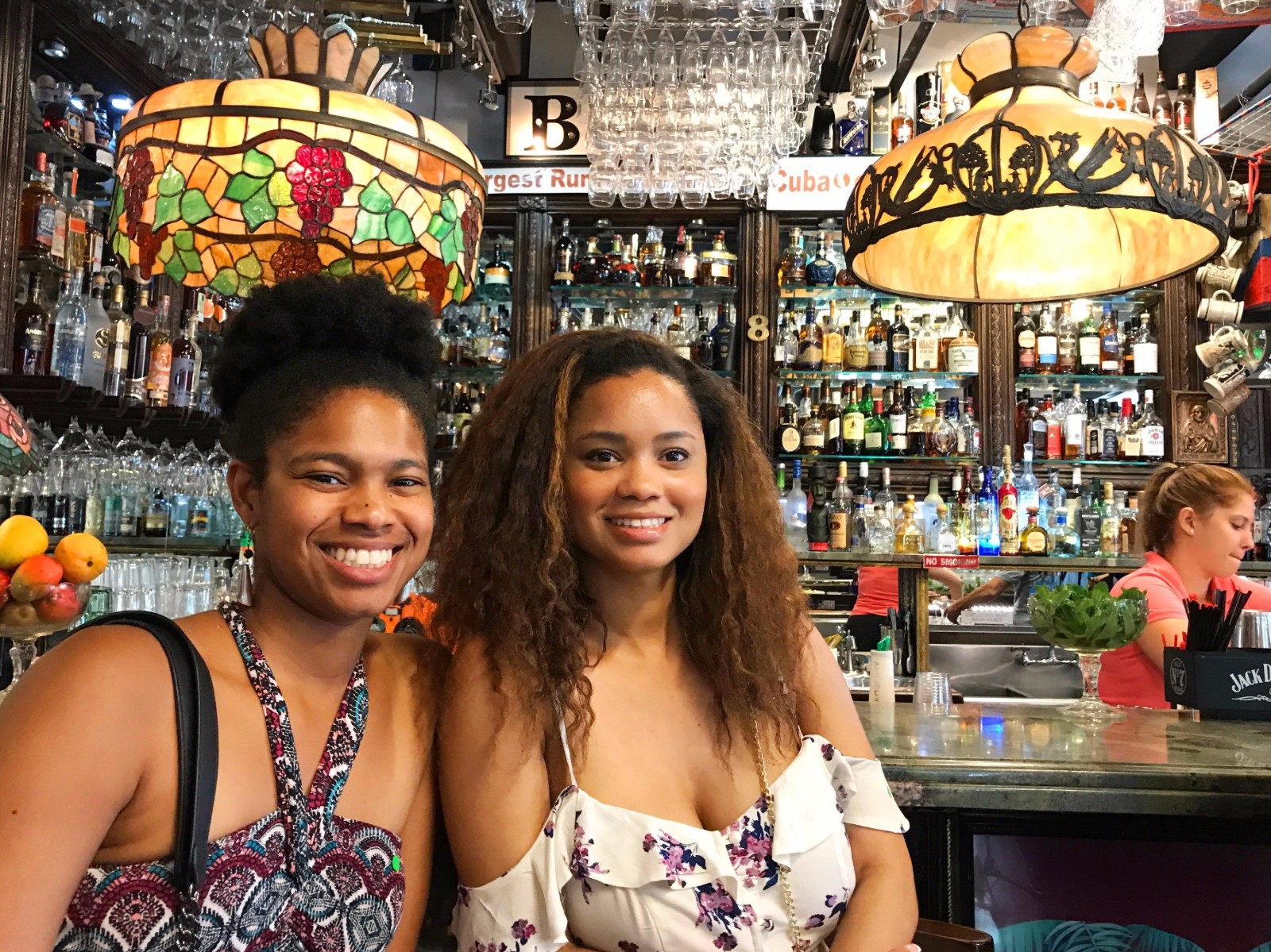 Two young ladies posing at the bar inside the Art Gallery in Little Havana