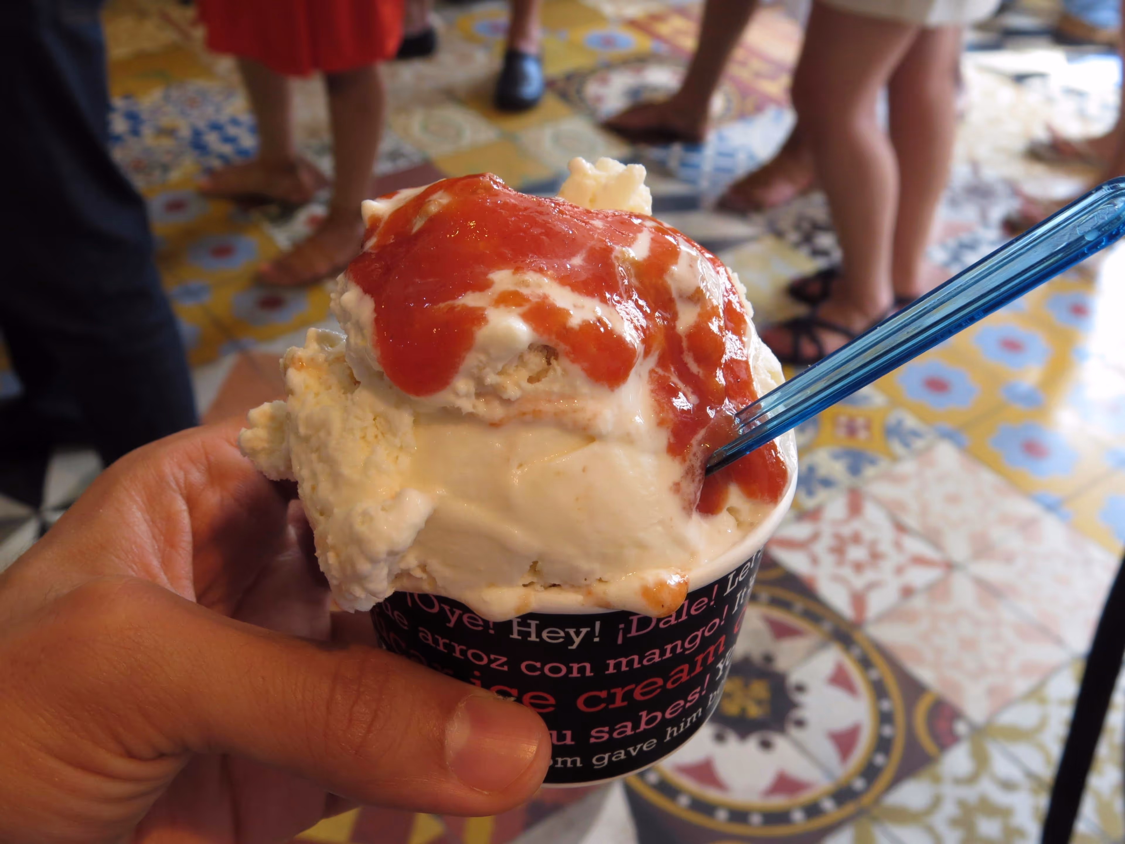 Close-up of a cup of guava ice cream overflowing with syrup