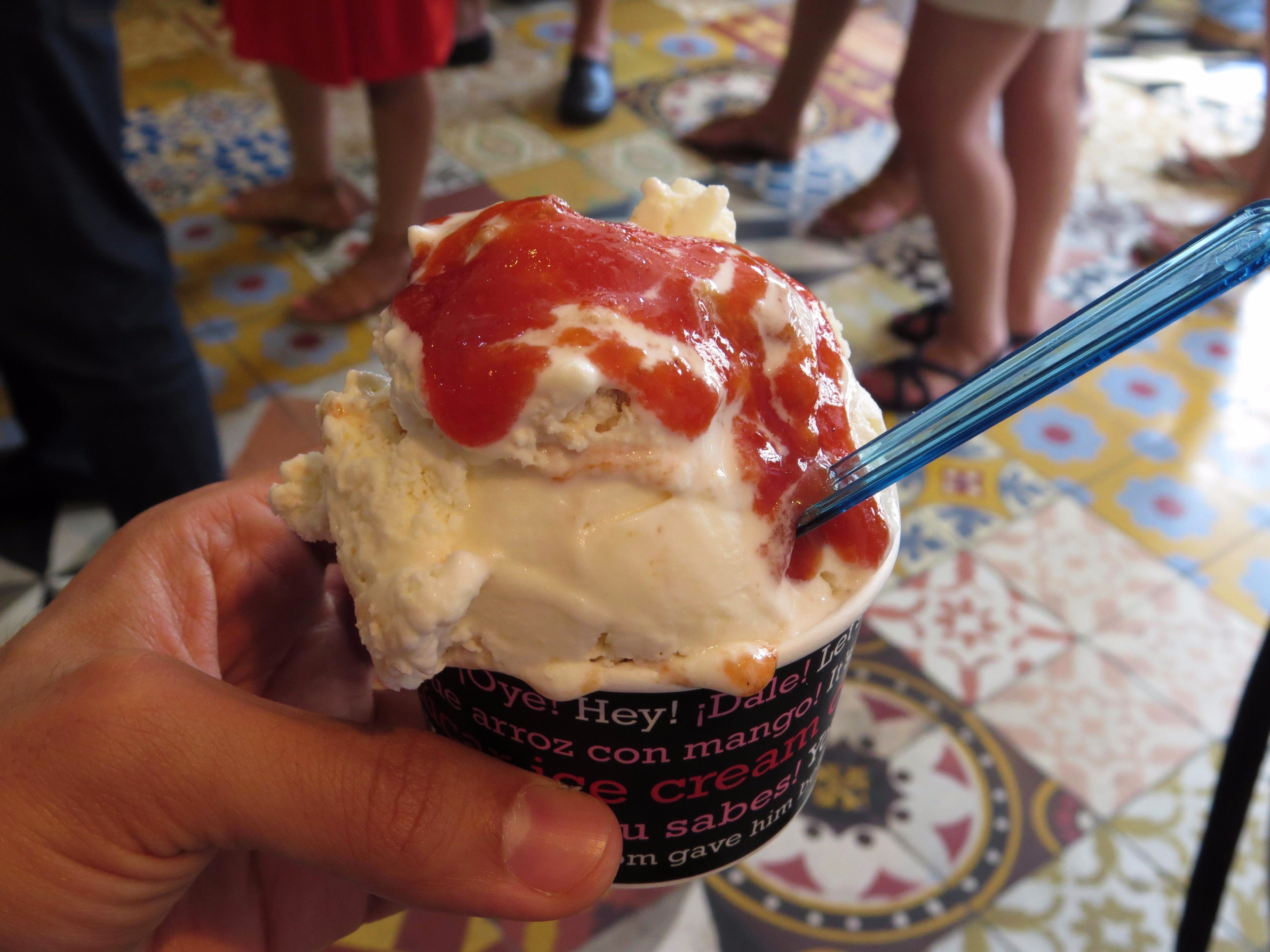 Close-up of a cup of guava ice cream overflowing with syrup