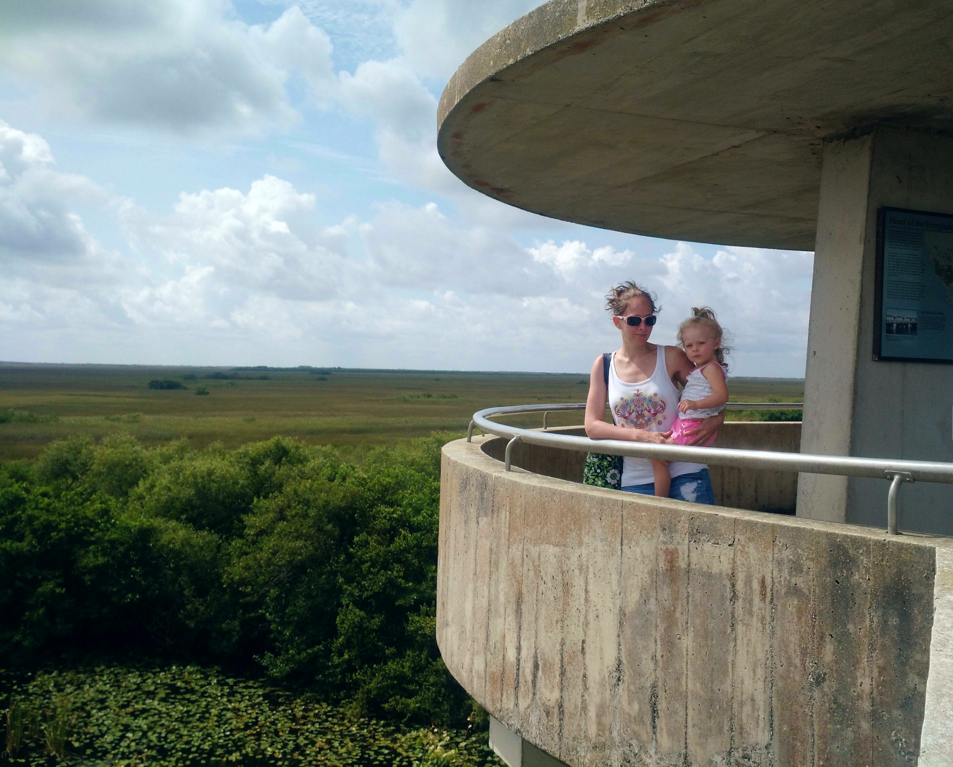 Mother holding her toddler on the observation tower, high above the Everglades