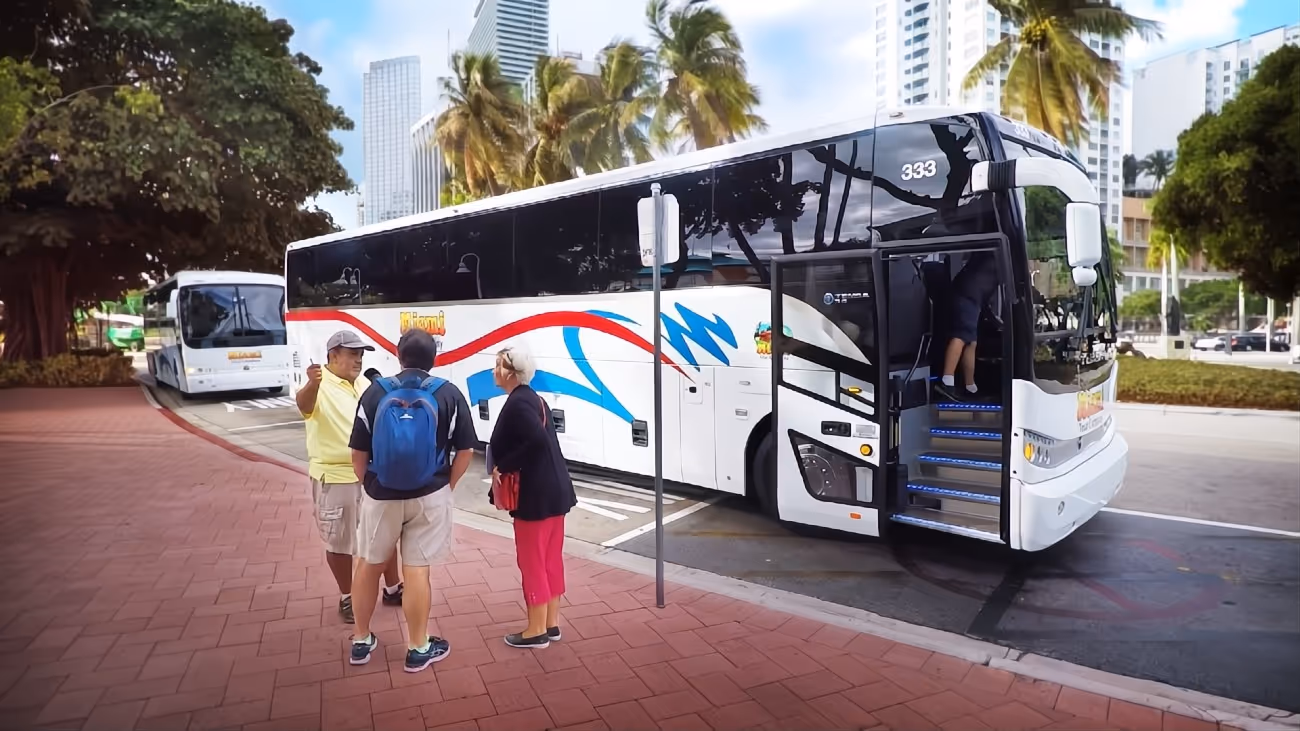 Bus driver greeting passengers at Bayside on a cloudy day