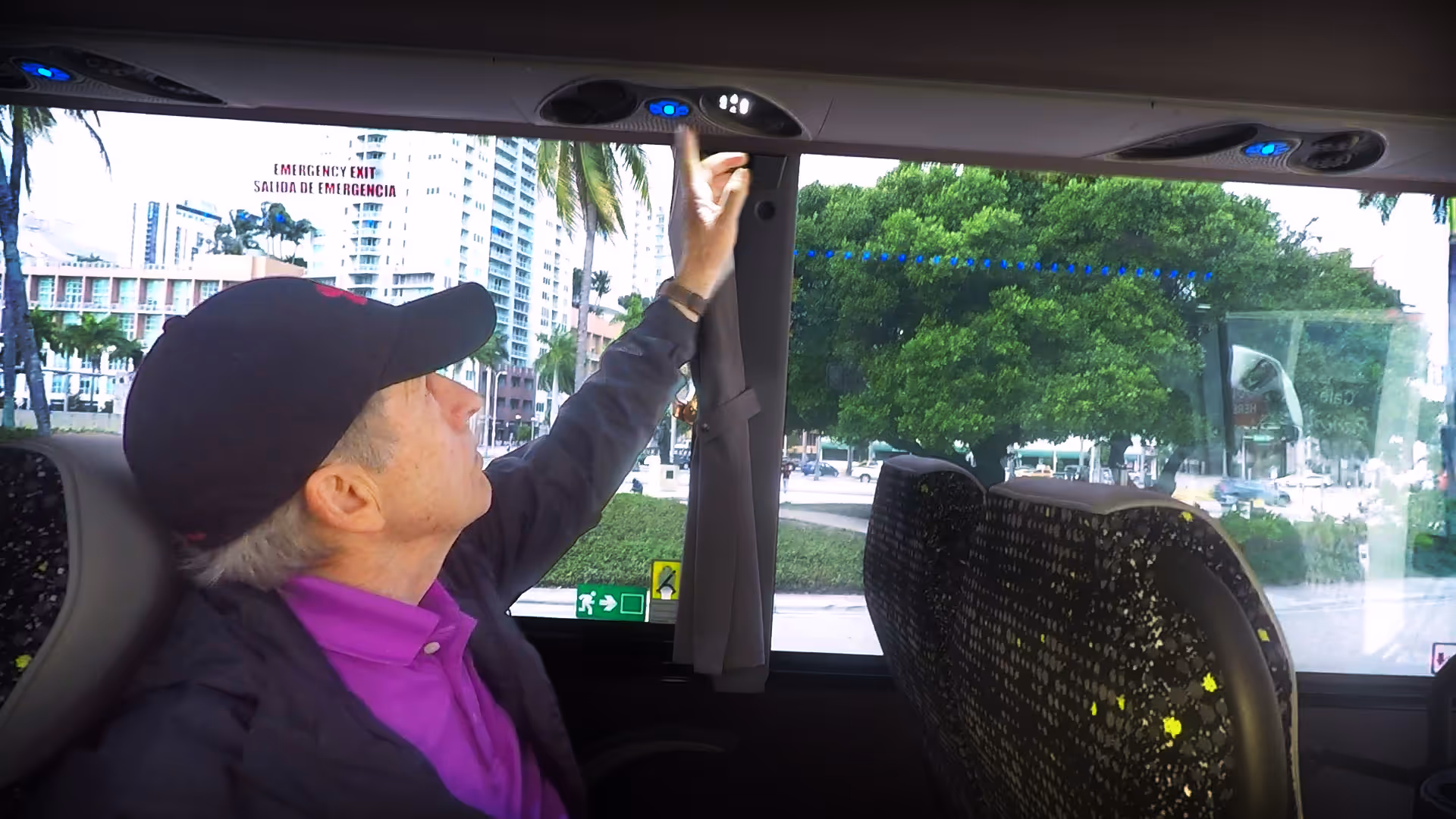 Tour bus driver showing how to operate air conditioning 