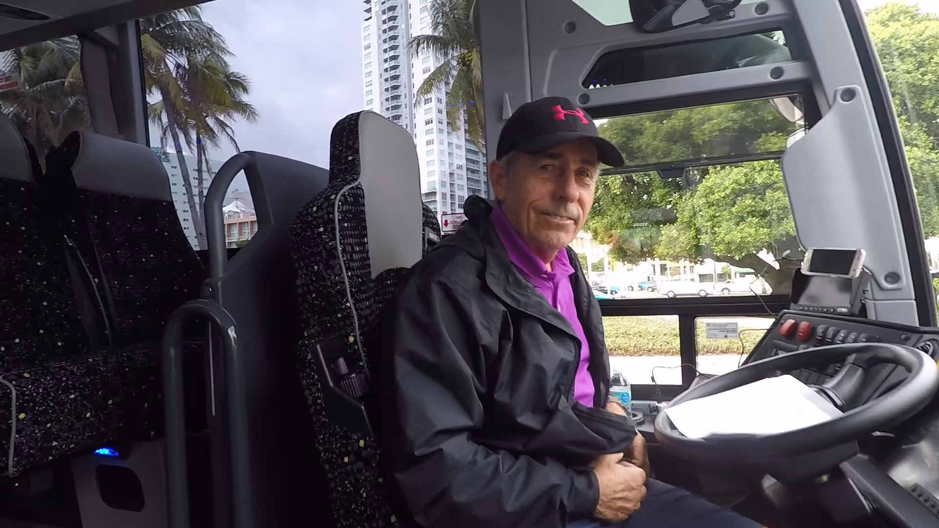 Smiling driver behind the wheel of the bus