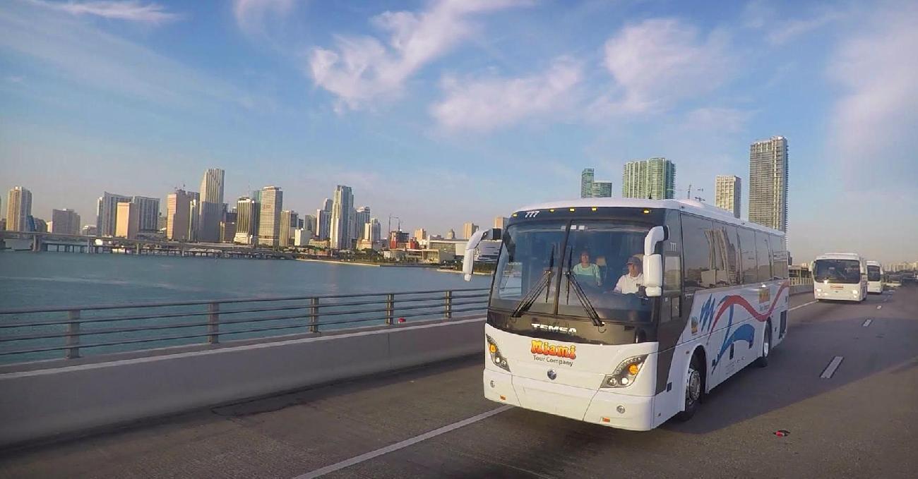 Charter bus driving over bridge to Port Miami