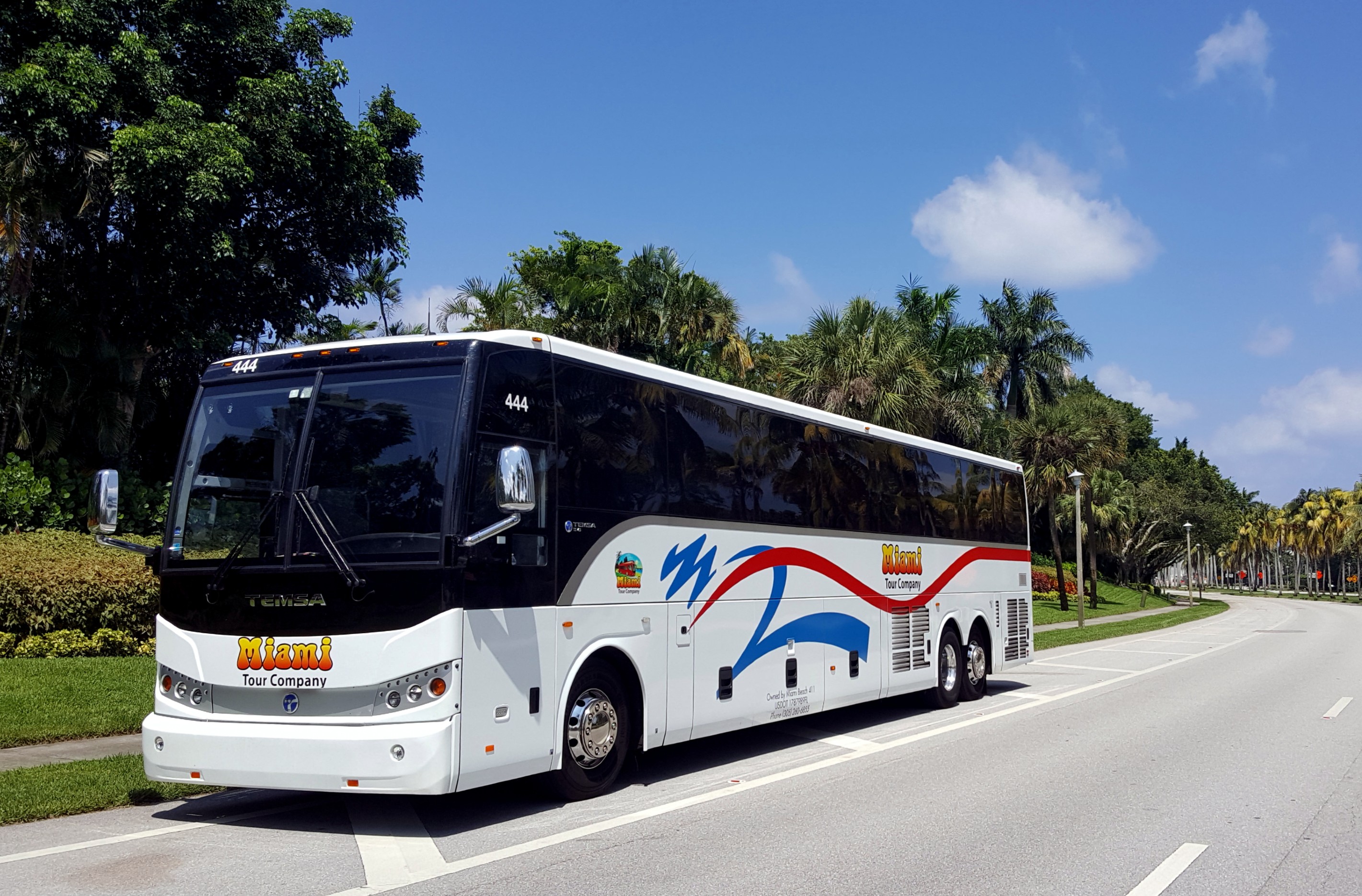 Bus charter rental on route to airport under sunny skies