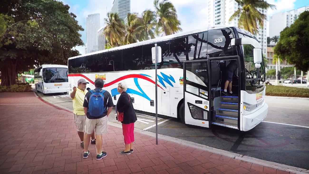 Bus driver greeting passengers at Bayside on a cloudy day
