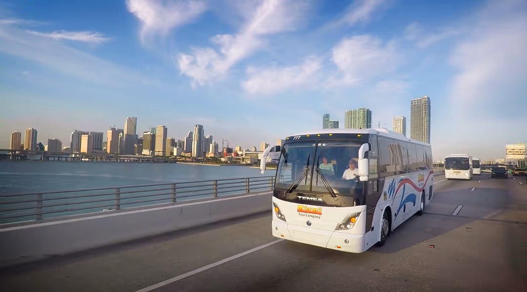Charter bus driving over bridge to Port Miami under sunny skies