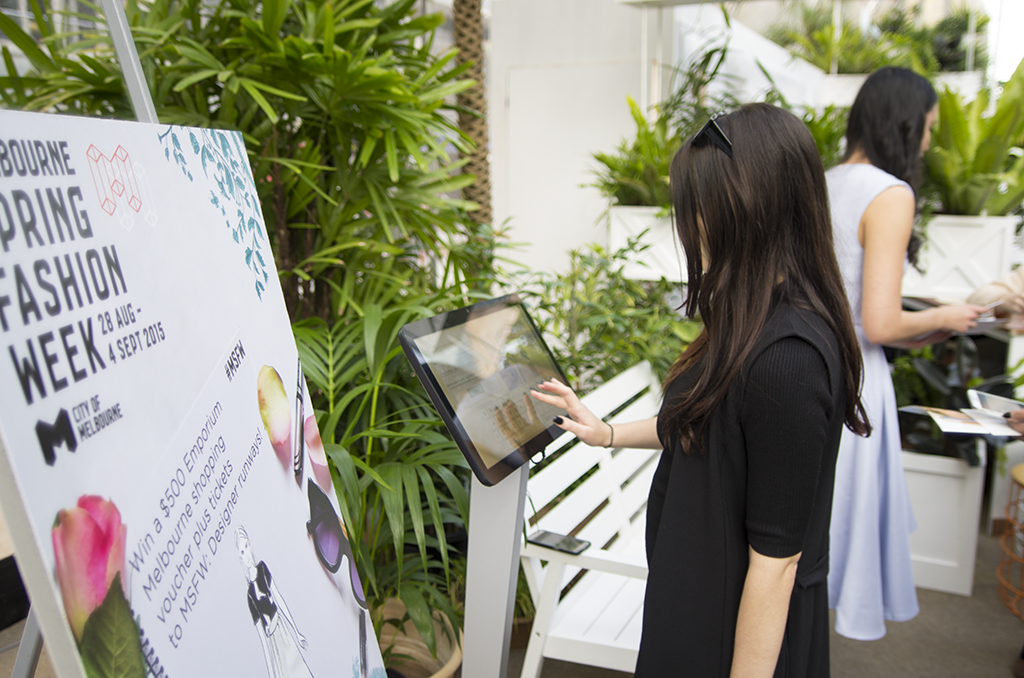 A photo of a patron using the Melbourne Spring Fashion Week Sketchbook.