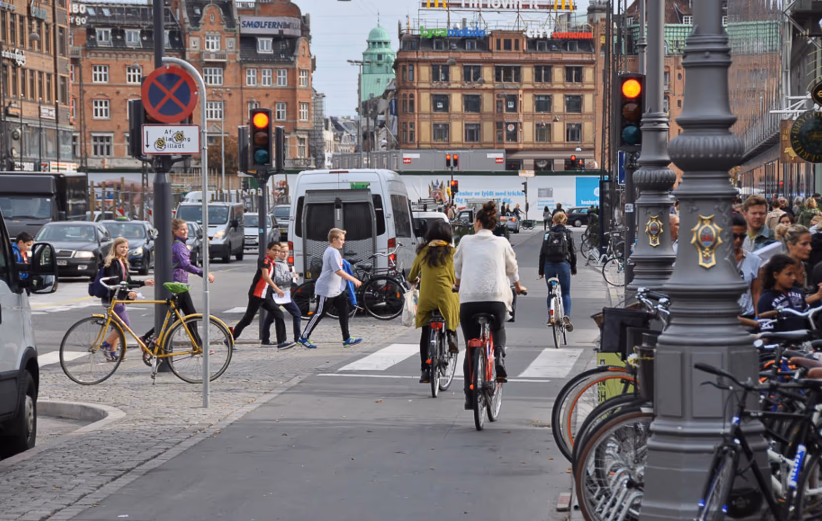 A woman riding a bike in a city street.