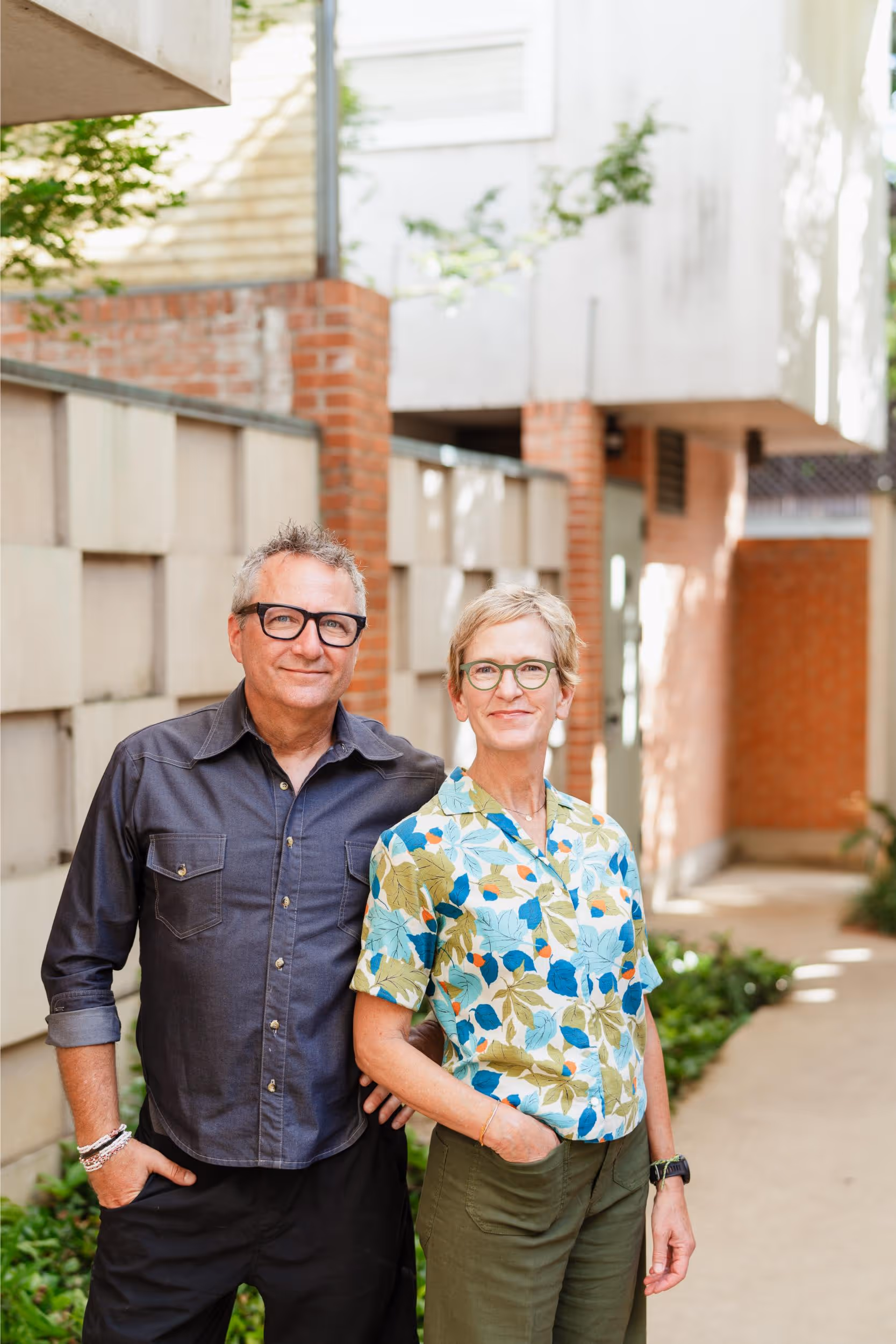 photo of owners sean and kelly in front of their home