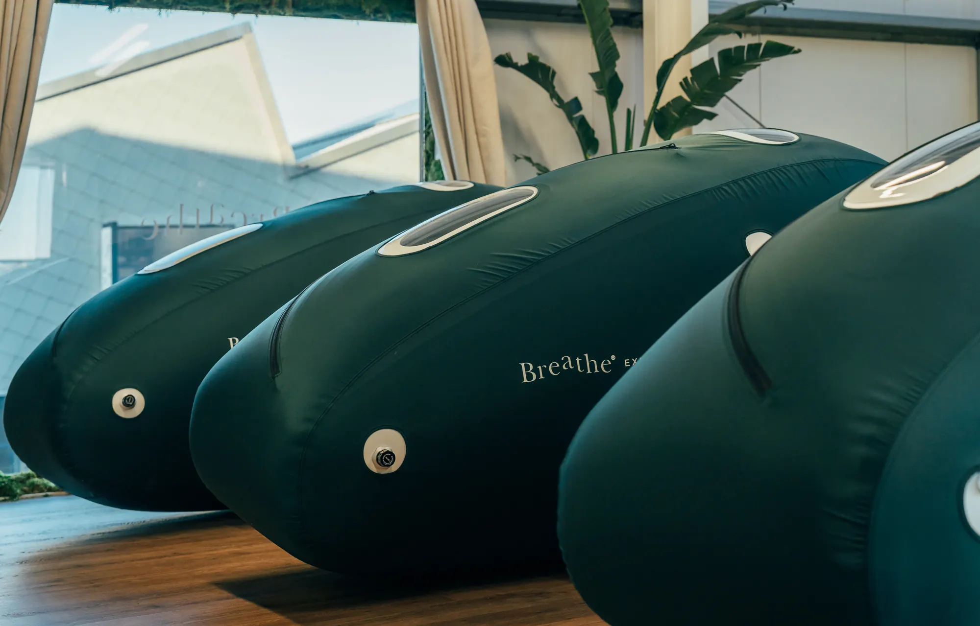 A row of Breathe hyperbaric chambers in the light-filled chamber room