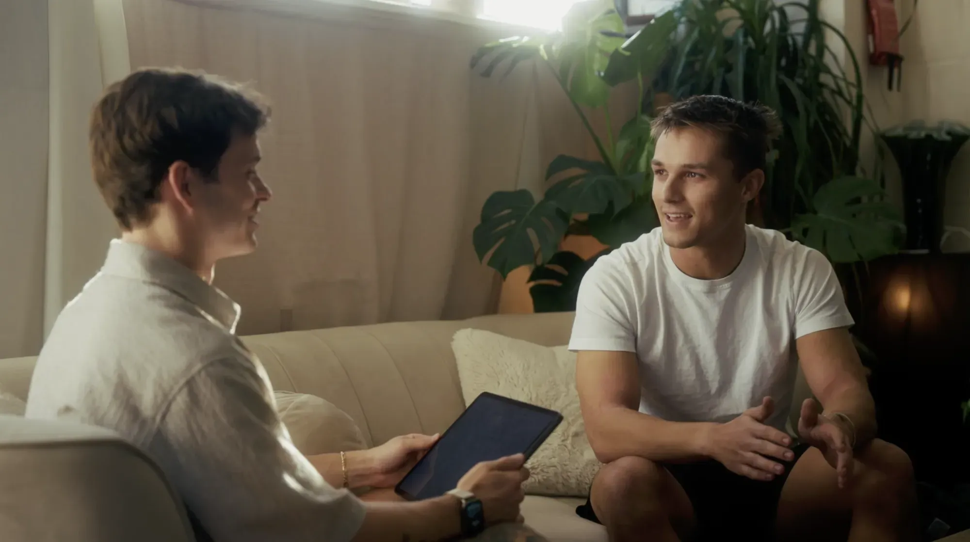 An athlete talking through his training with a Breathe practitioner in the Breathe lounge