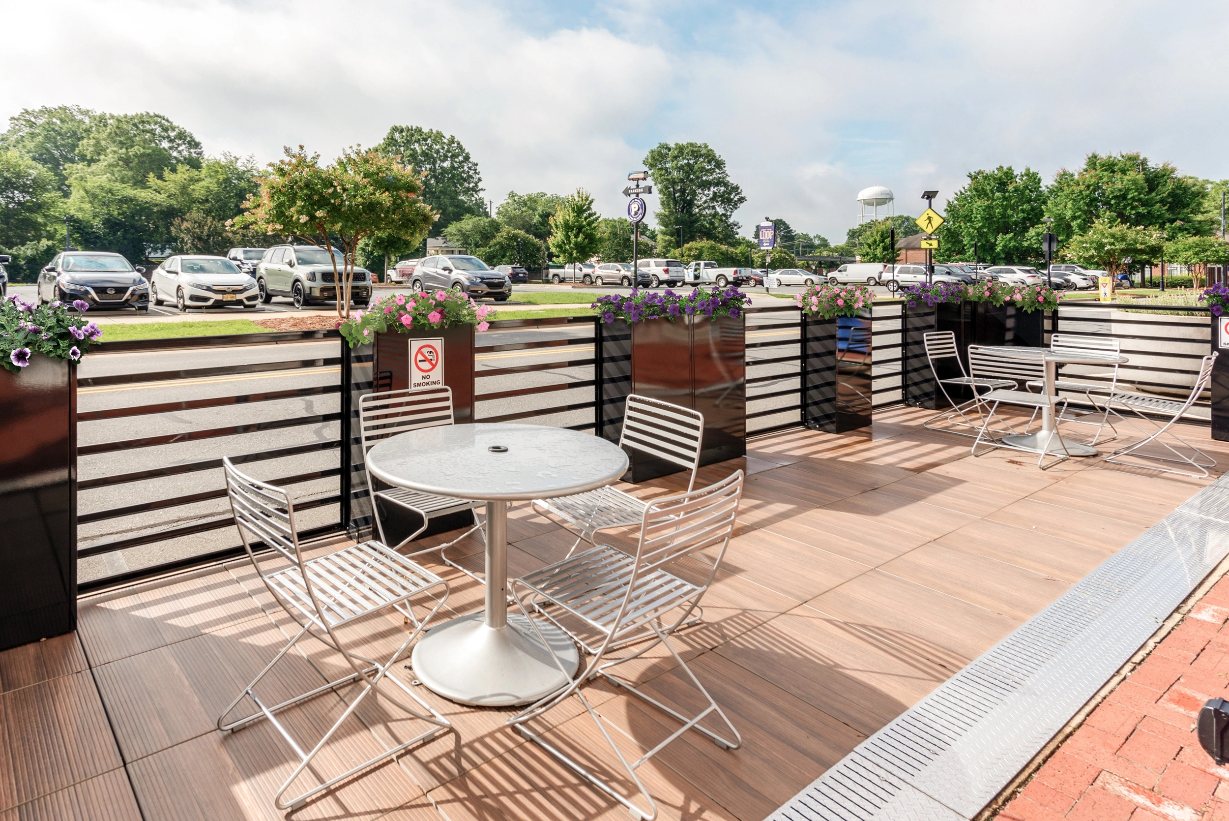 A row of vibrant red umbrellas lined up against a neutral background, creating a striking visual contrast.