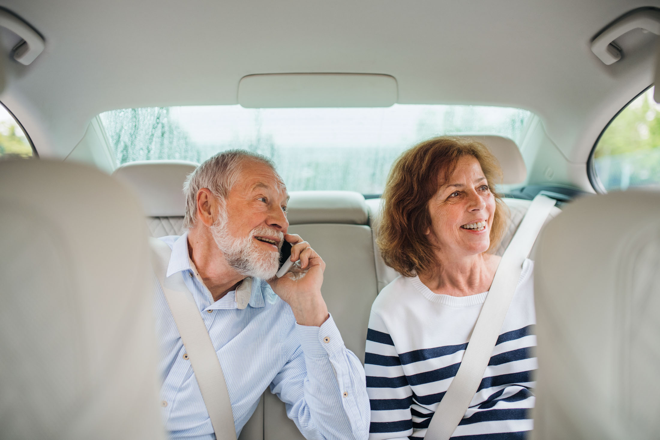 Passengers talking in the back seat of a transfer vehicle