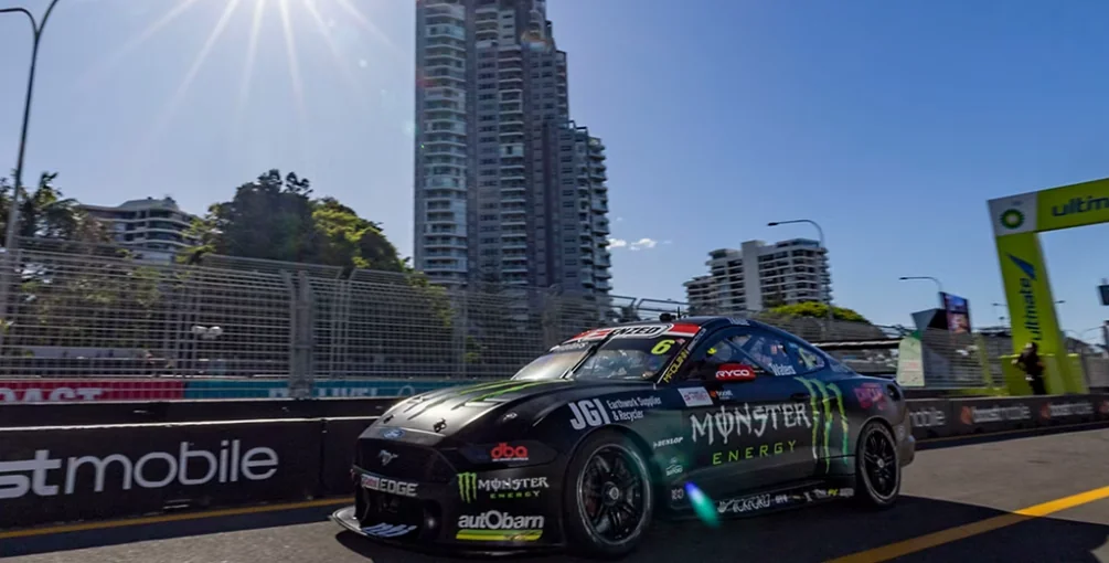 A Supercar racing on the Surfers Paradise Street Circuit past beachfront high-rises