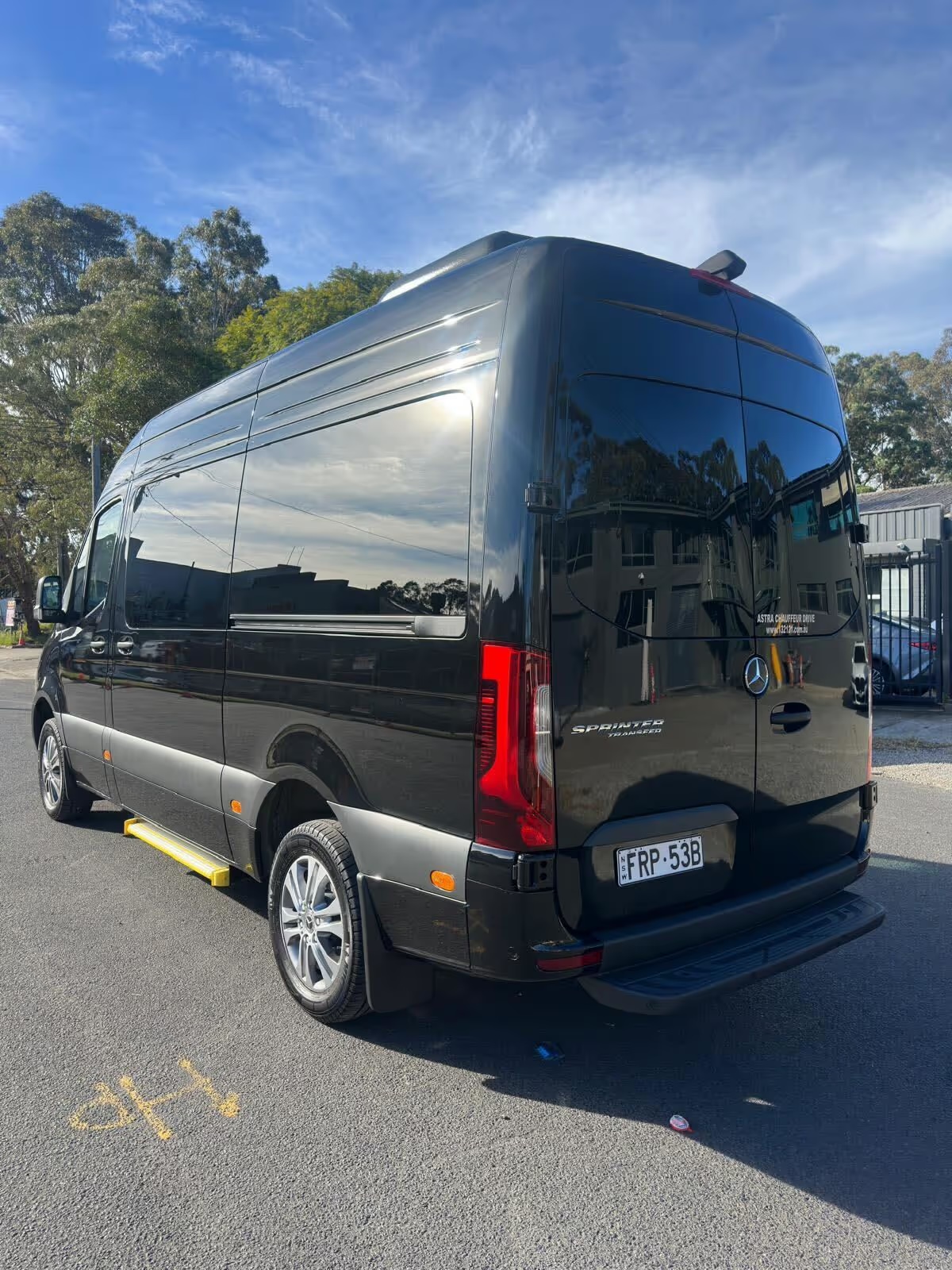 Black Mercedes-Benz Sprinter minibus, rear three-quarter view