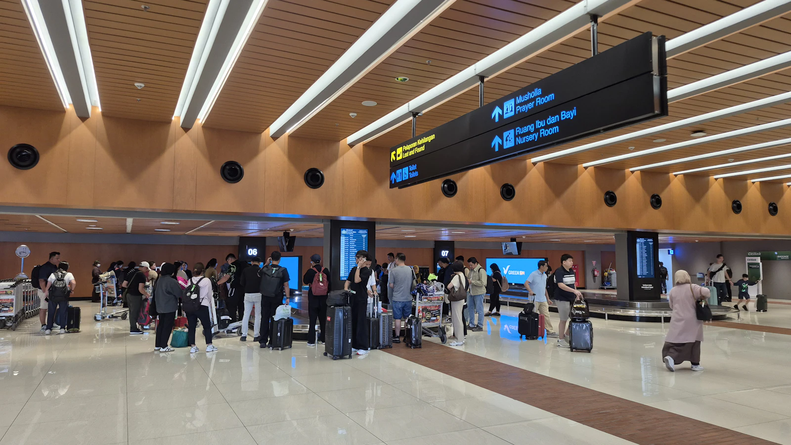 Travellers with luggage in a modern airport check-in hall