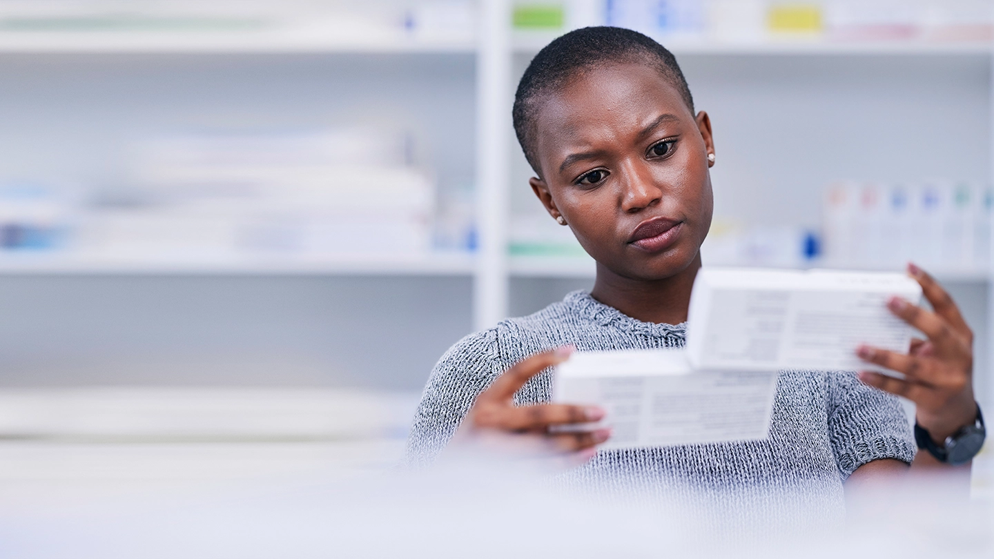 Women looking at two medication boxes of semaglutide and tirzepatide.