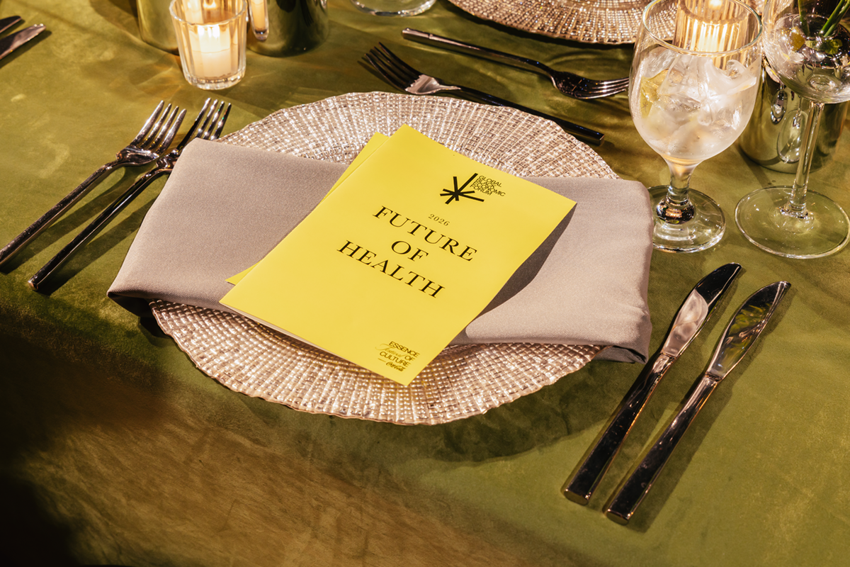 A 2026 Future of Health program on a charger plate at a candlelit place setting at the Global Black Economic Forum dinner.