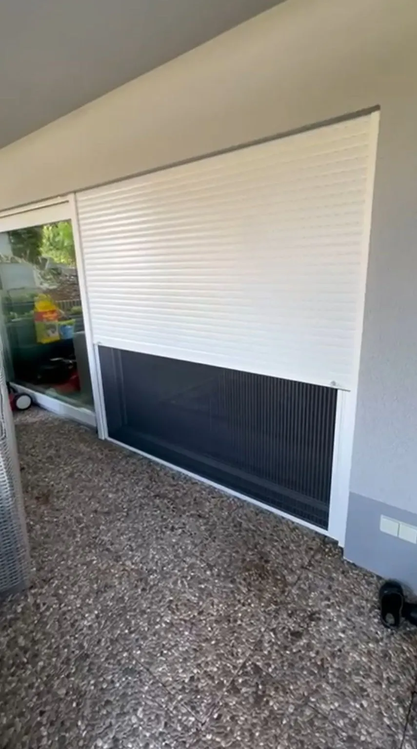 View behind roller shutter showing integrated insect screen – installation detail