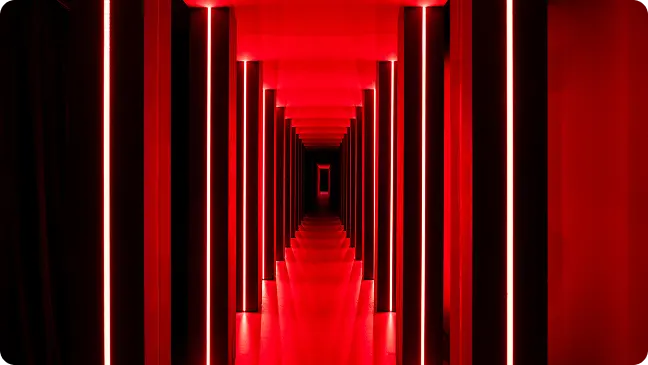 Bathed in glowing reds, light melts space into a festive stream of motion.