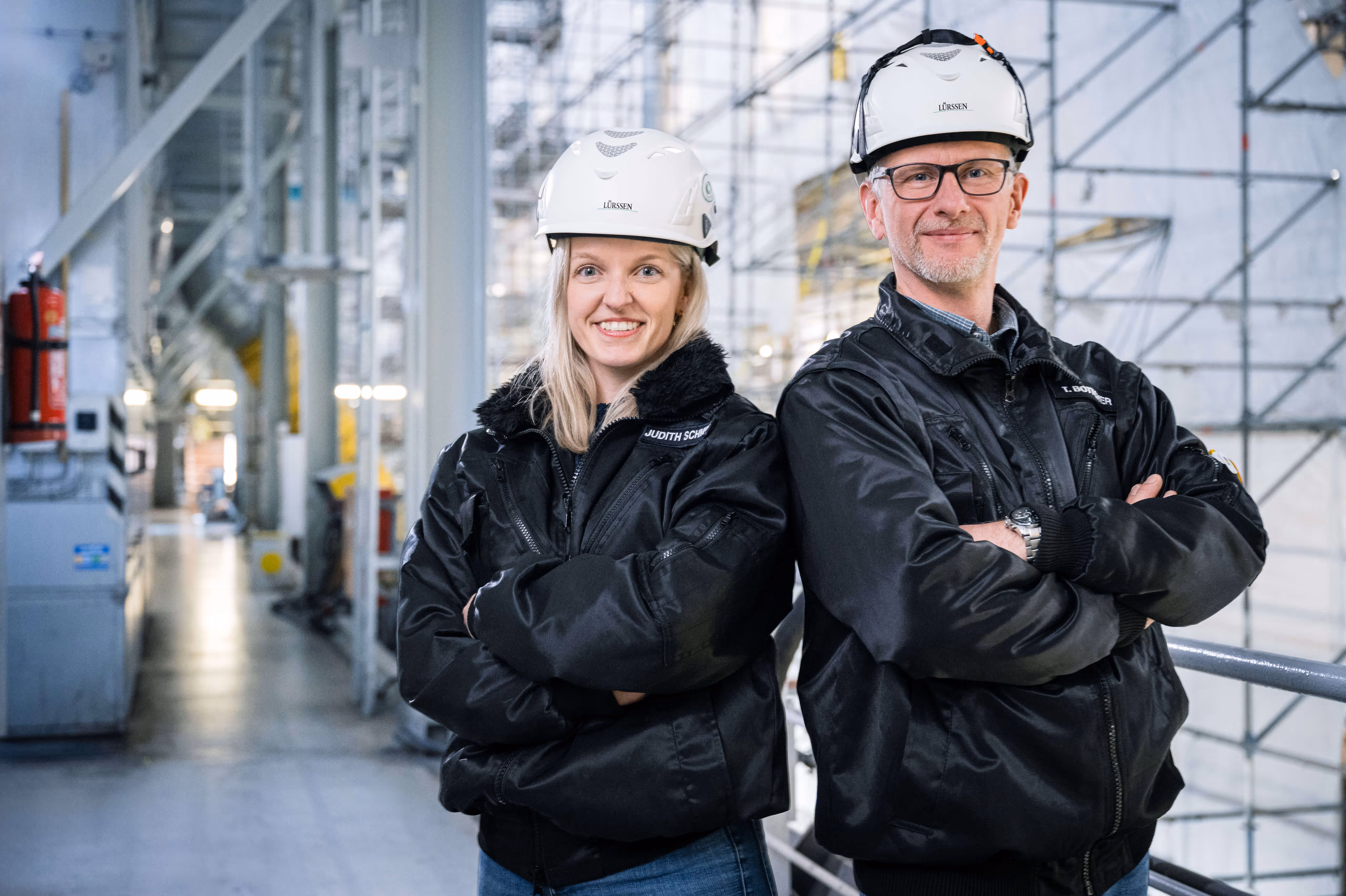 Male and female worker standing together