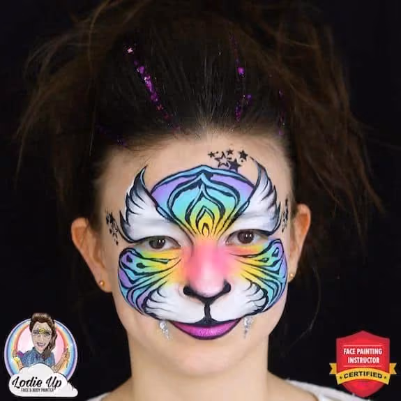 a young girl with a colorful tiger face paint design