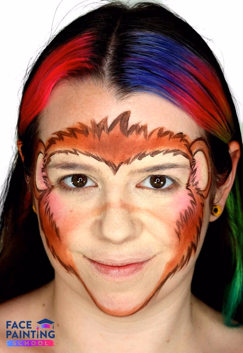 a girl wearing a compleated monkey face paint design