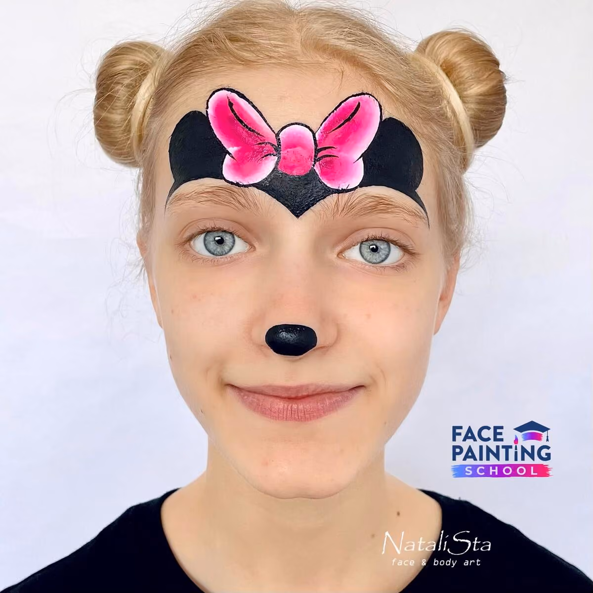 a girl with a detailed pink bow and minnie mouse ears painted on her face