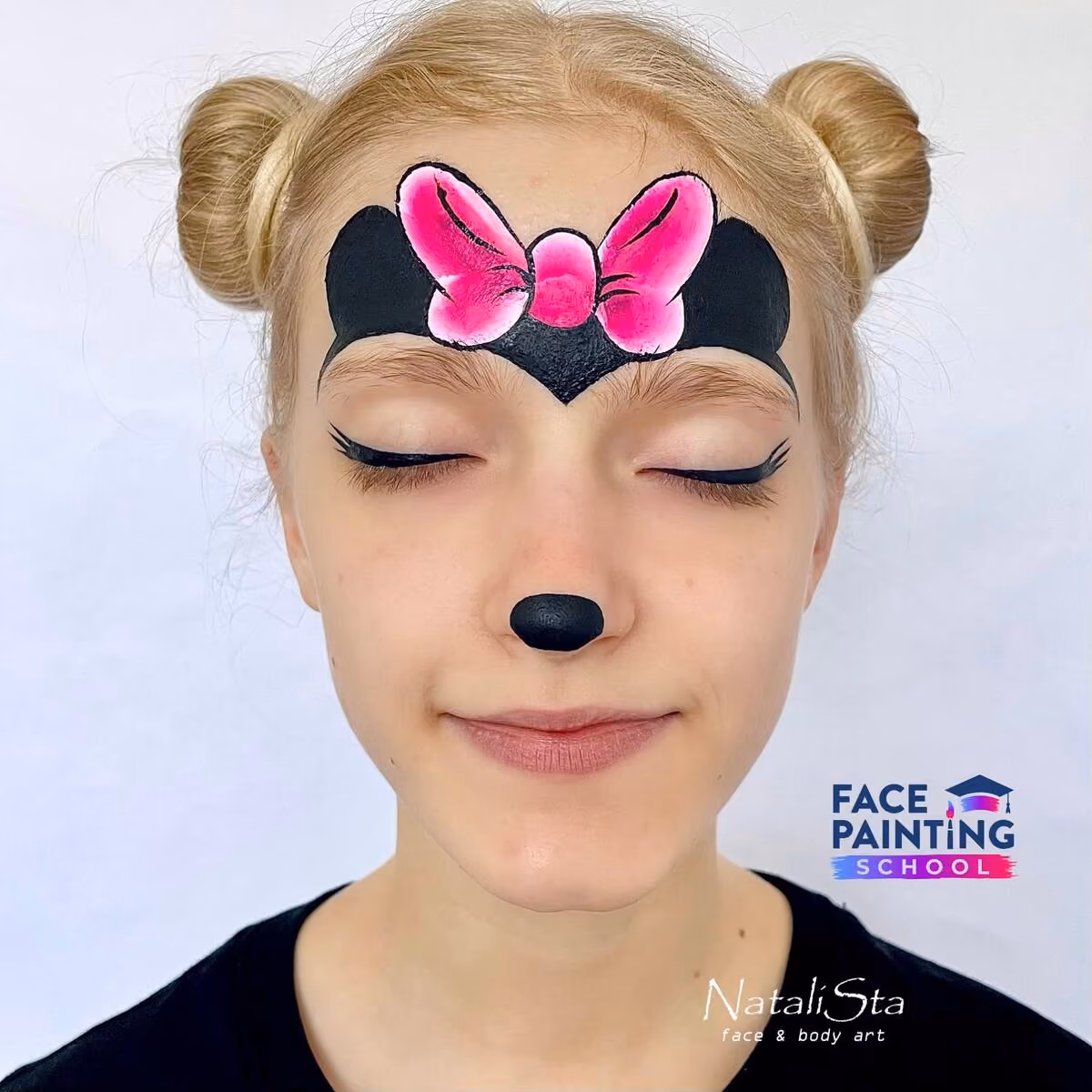 a girl with her eyes closed wearing a compleated minnie mouse face paint design