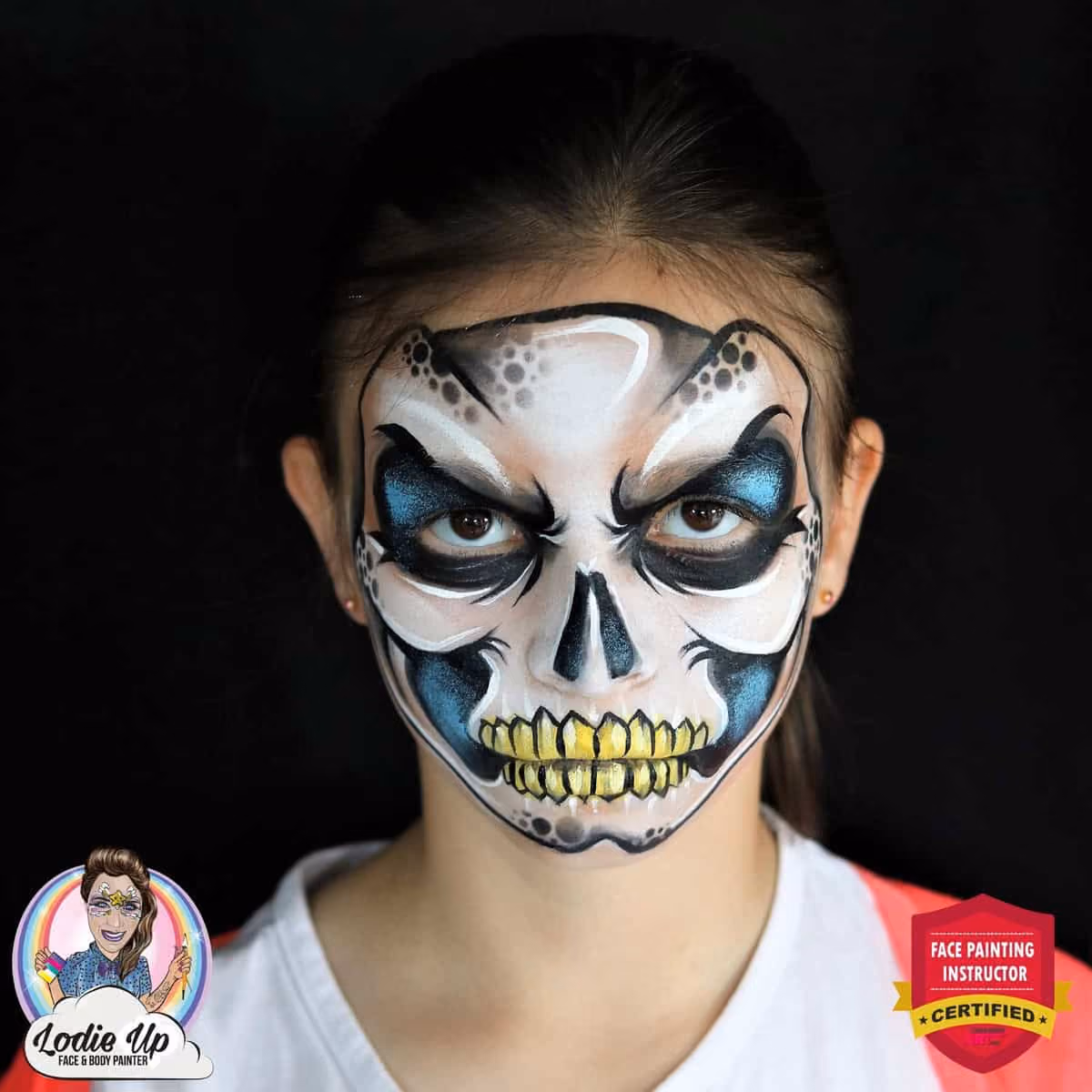 direct image of a girl with a completed skeleton face painting looking mean