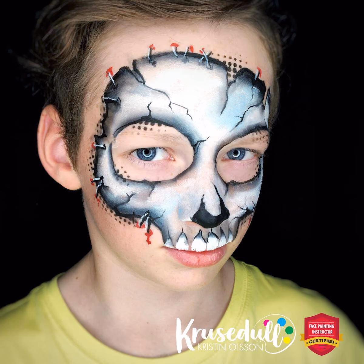 a boy looking at the camera at an angle wearing a compleated skull mask face paint design