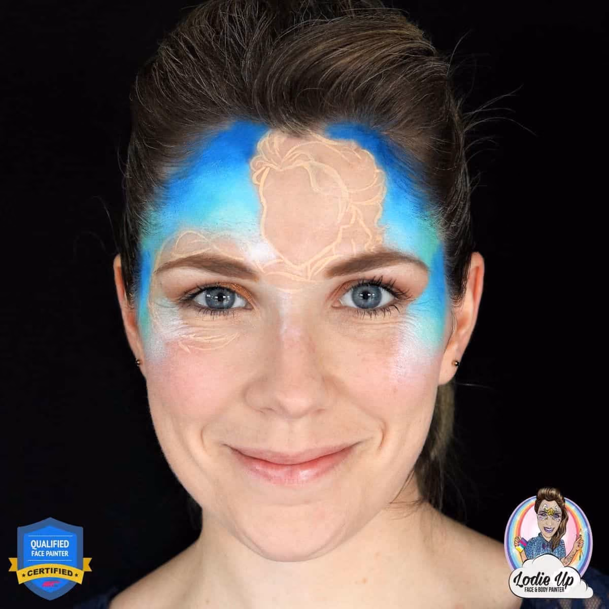 a woman wearing an outline of the elsa face paint design with a blue background