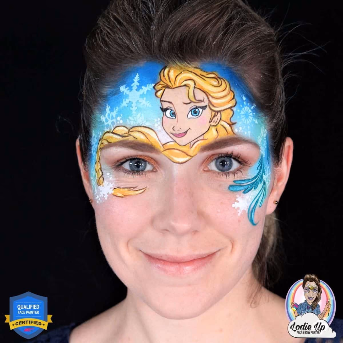 a woman with a finished elsa face paint design on her forehead