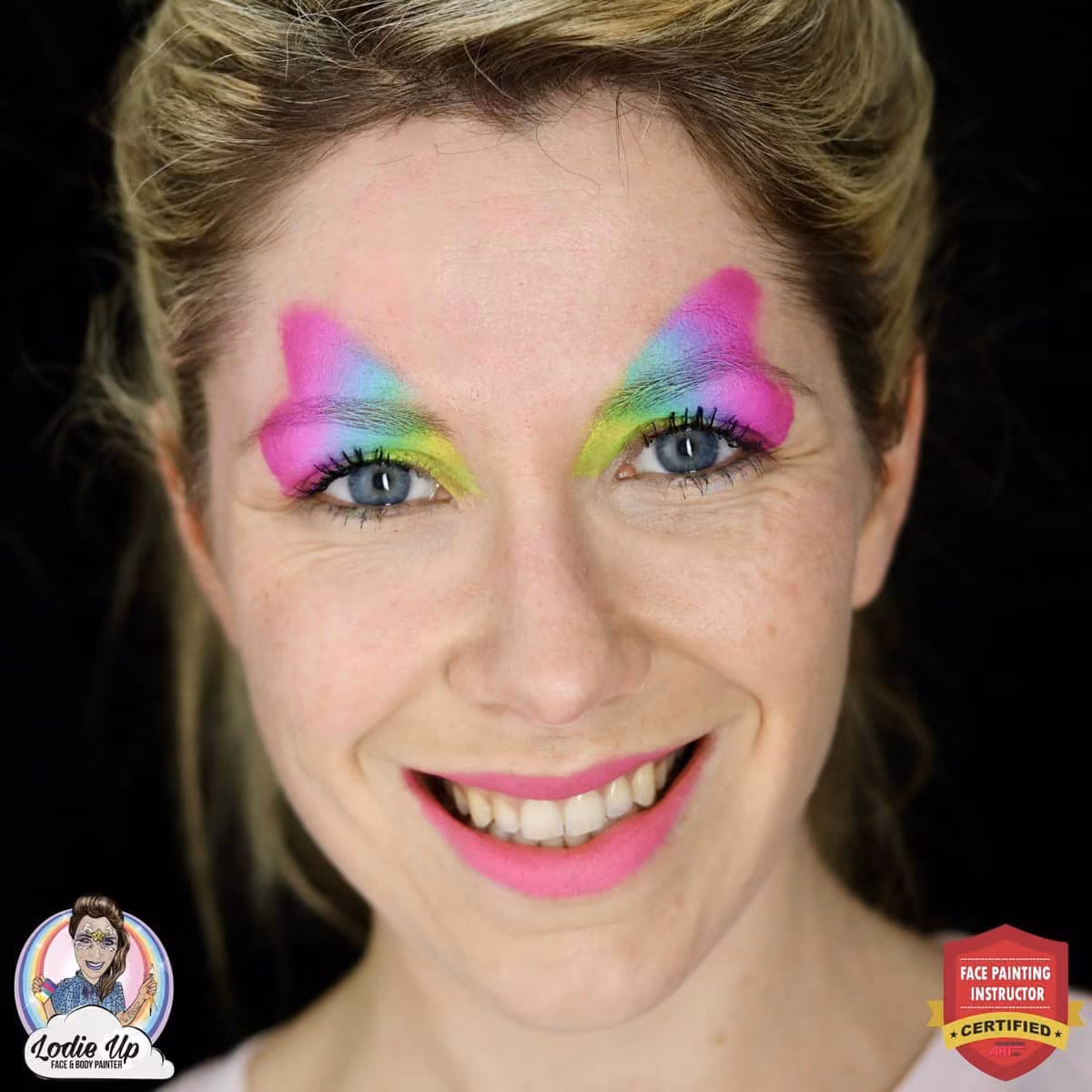 a woman with a gradient face paint on and above her eyes