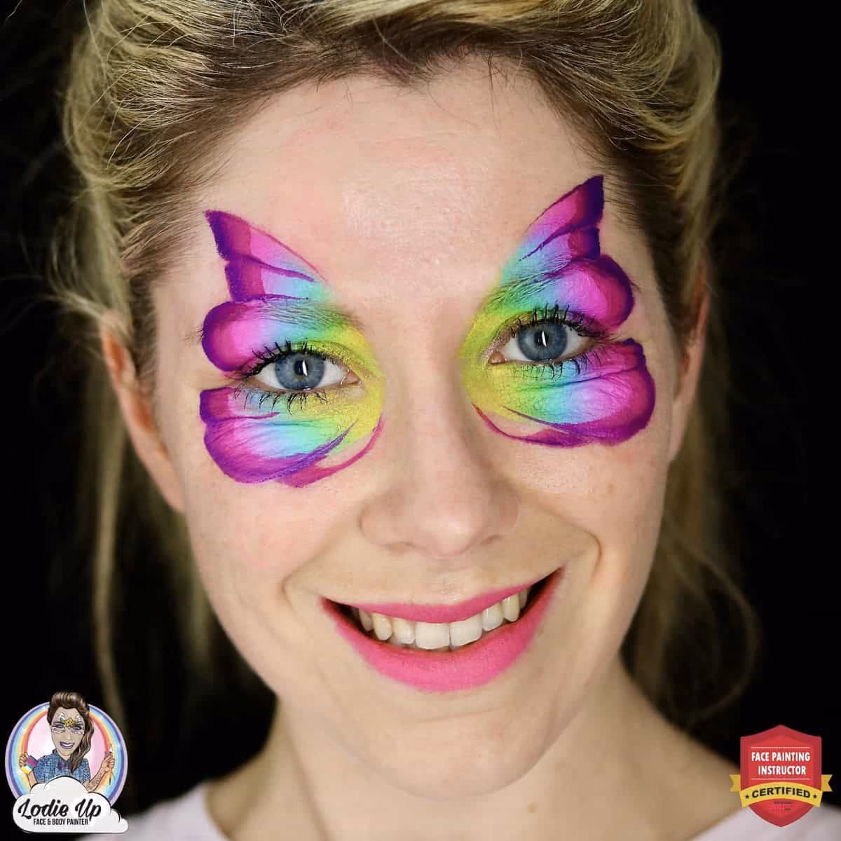 a woman with gradient butterfly wings that are shaded painted on her eyes