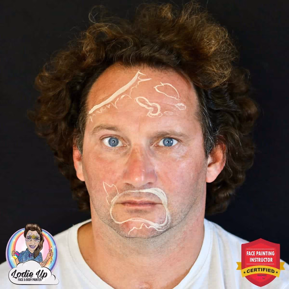 a man looking at the camera with the outline of the zombie face paint on his face