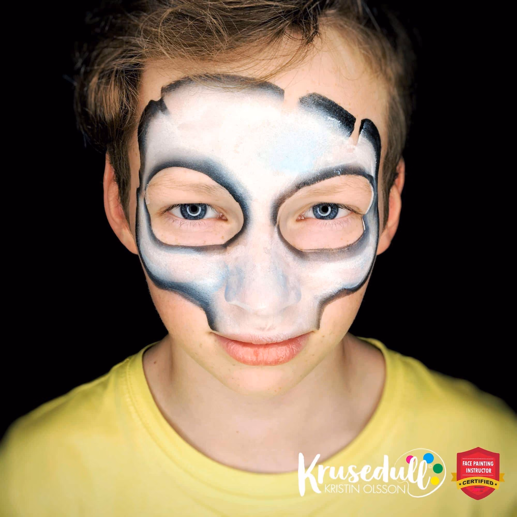 a boy with a countured skull mask face painting filled with white
