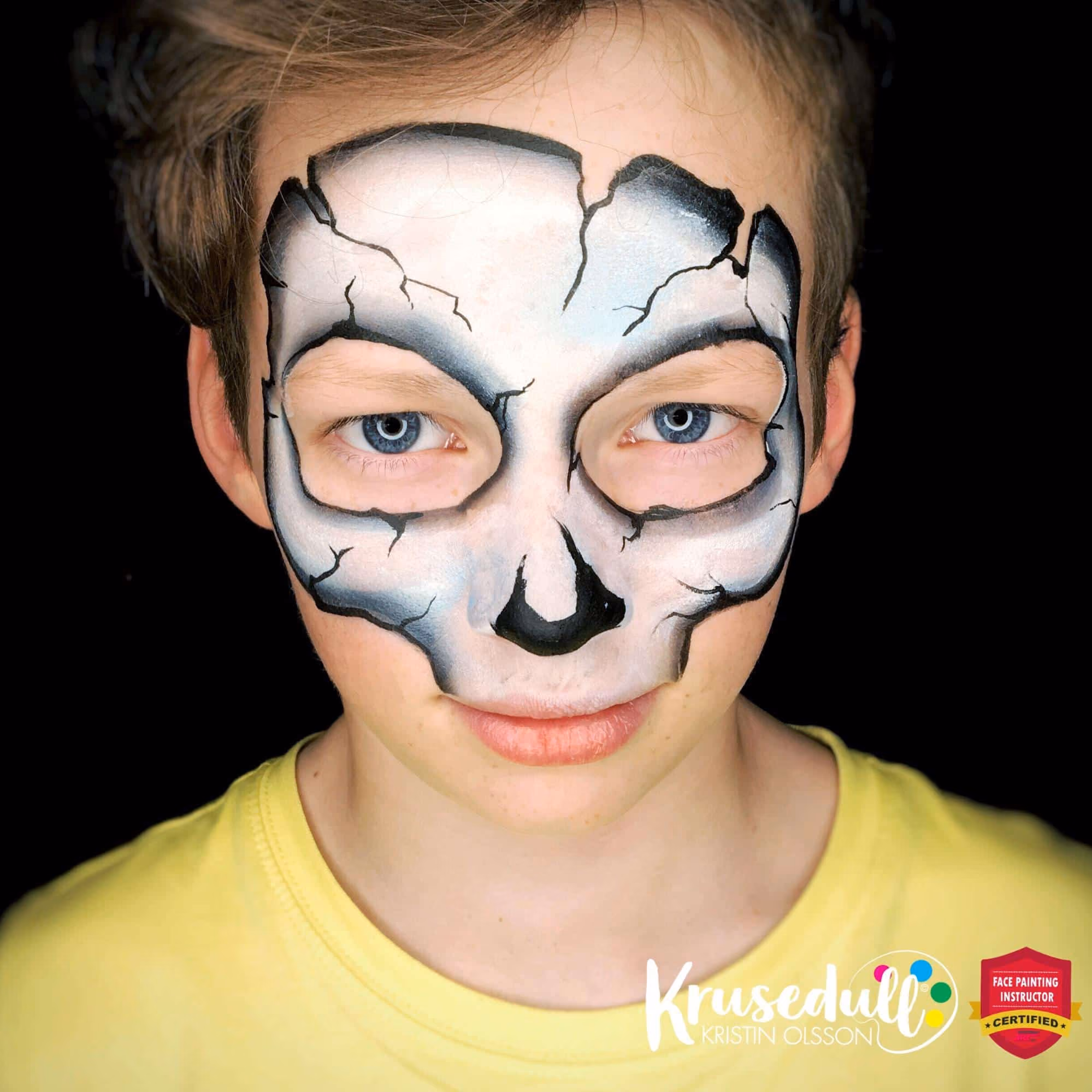 a boy with a countured skull mask face painting thats more shaded and with added cracks