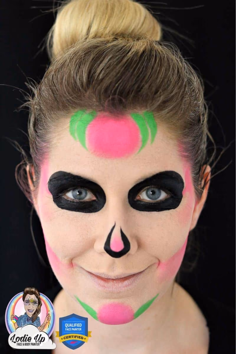a woman looking at the camera with a sugar skull face paint base on her face and around her eyes