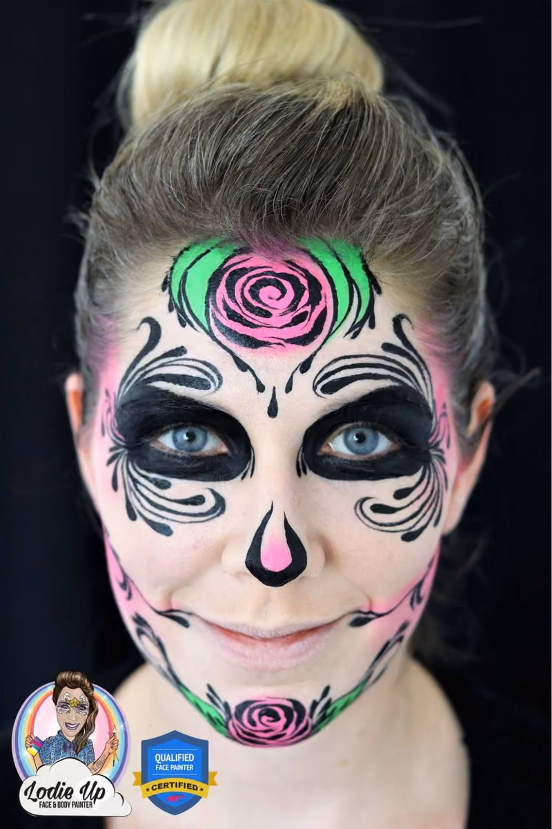 an image of a woman looking at the camera with a completed sugar skull face paint design