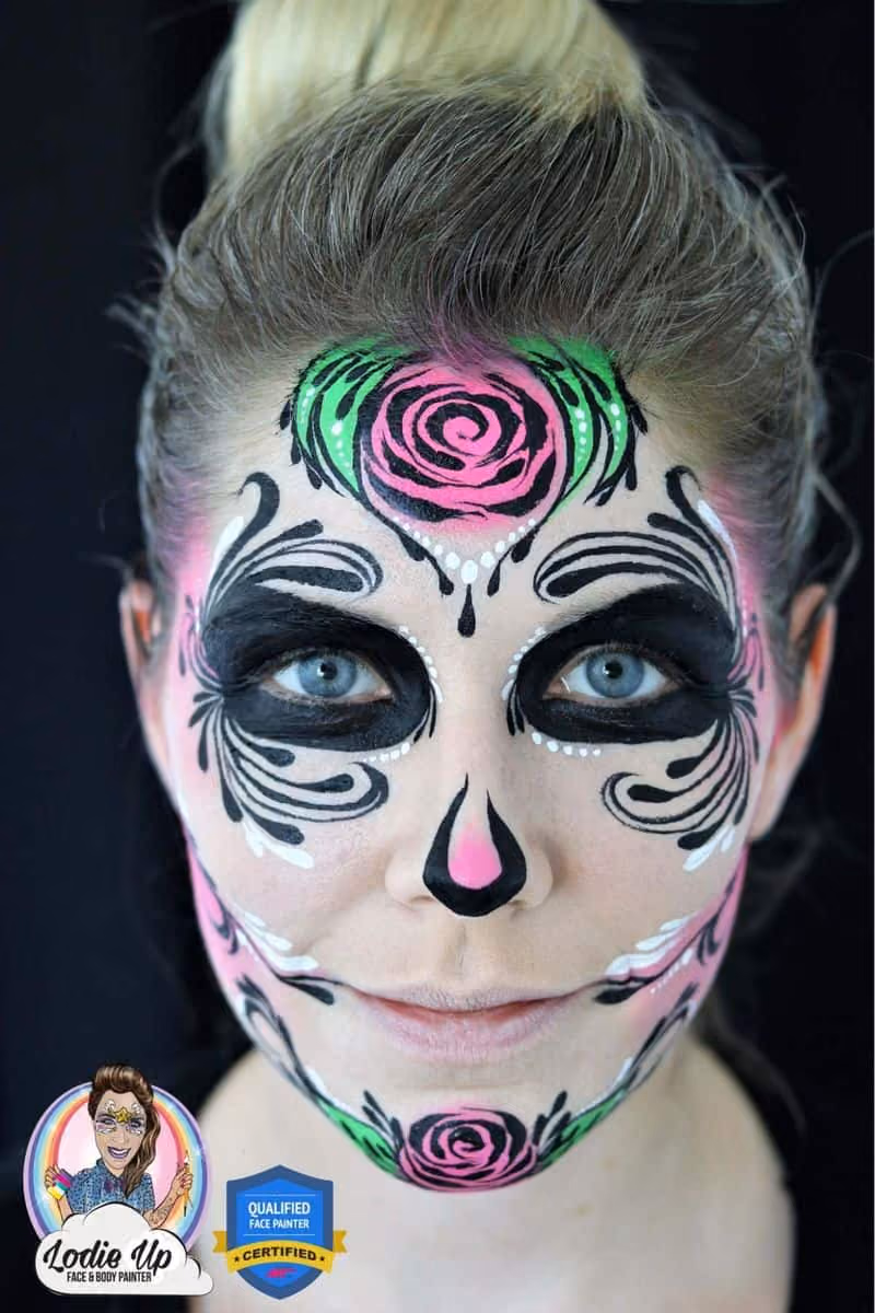 a woman looking at the camera with a completed sugar skull face paint desing