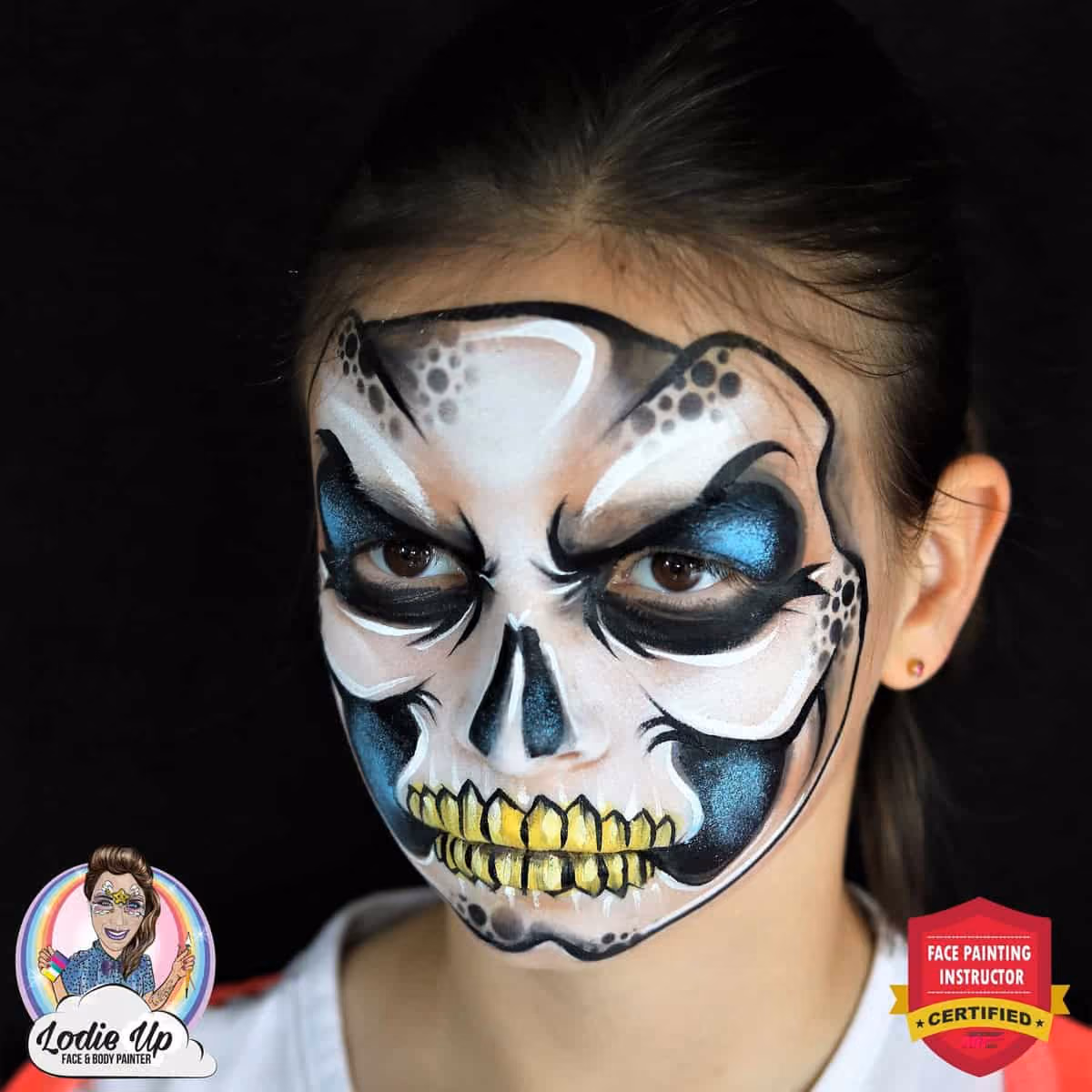 side image of a girl with a completed skeleton face painting looking mean