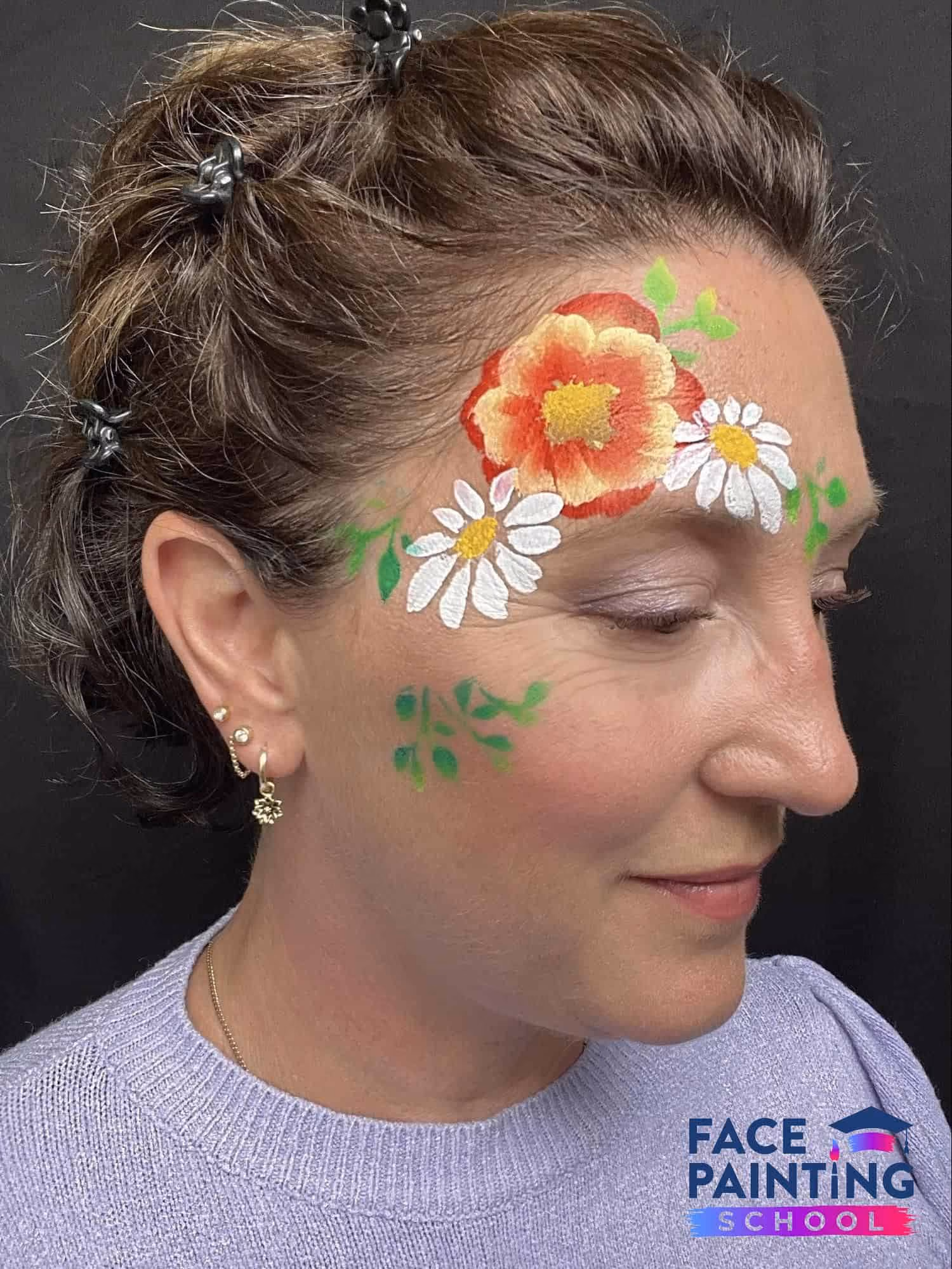 woman looking to the side with flowers painted on her face
