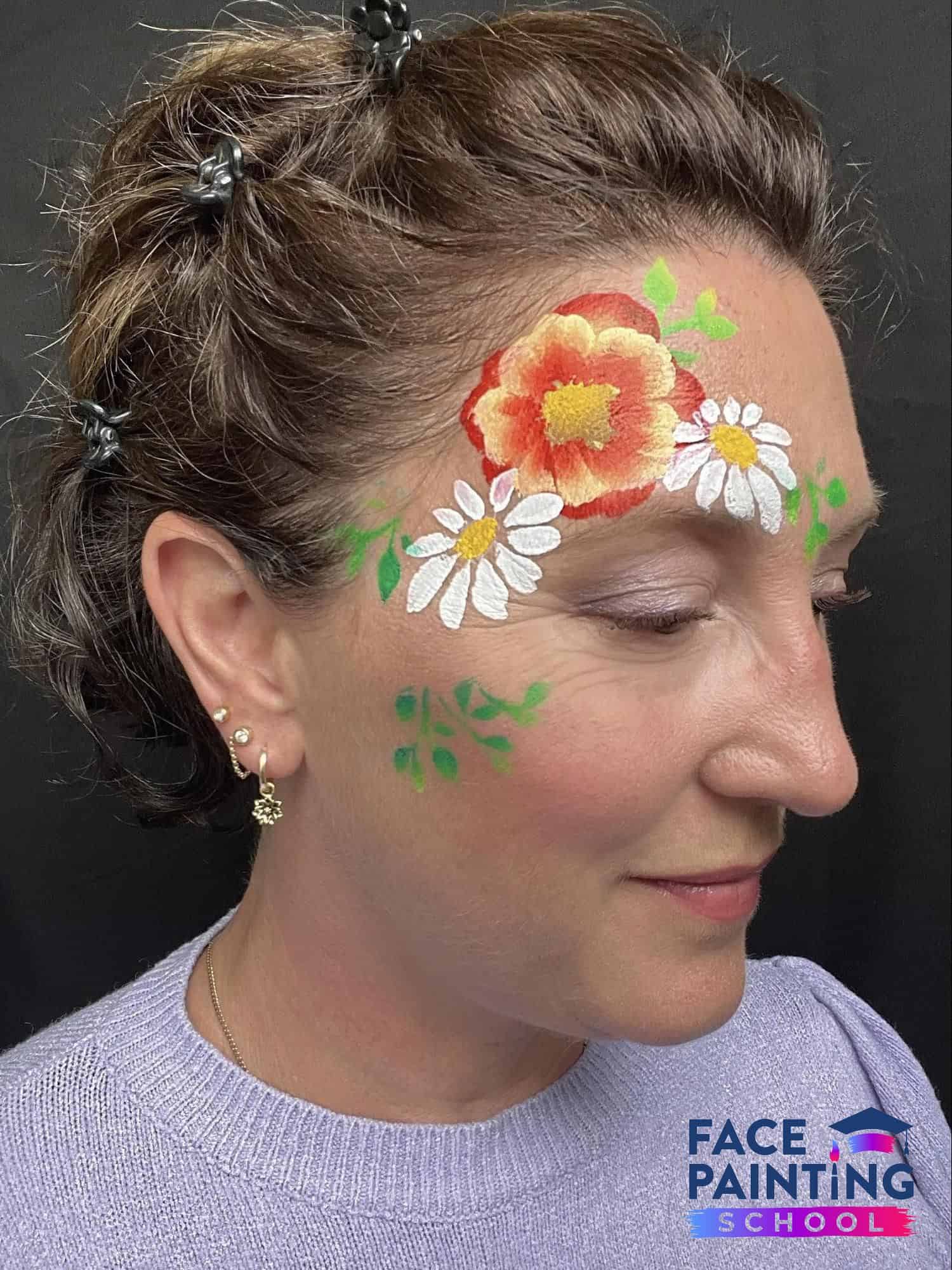woman looking to the side with flowers painted on her face