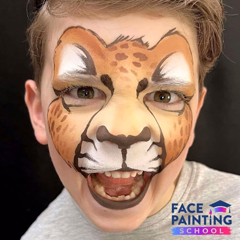 a boy roaring with a compleated cheetah face paint design
